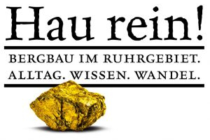 Zu sehen das Veranstaltungsplakat, das unter einem Schriftzug einen vergoldeten Kohlebrocken zeigt.